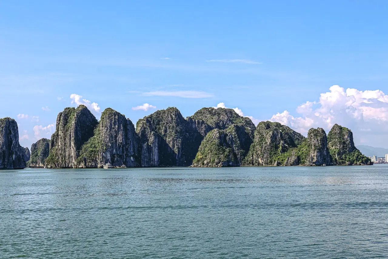 Stunning capture of Ha Long Bay's iconic limestone karsts under a clear blue sky.