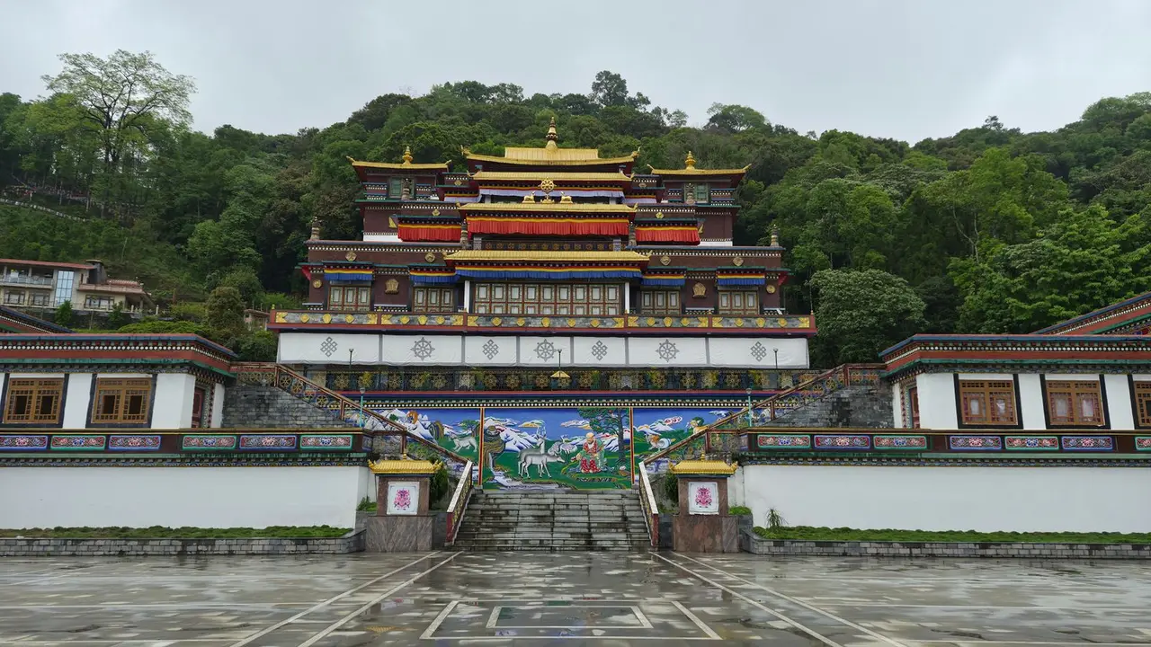 Front view of Rumtek Monastery surrounded by lush greenery in Sikkim, India.