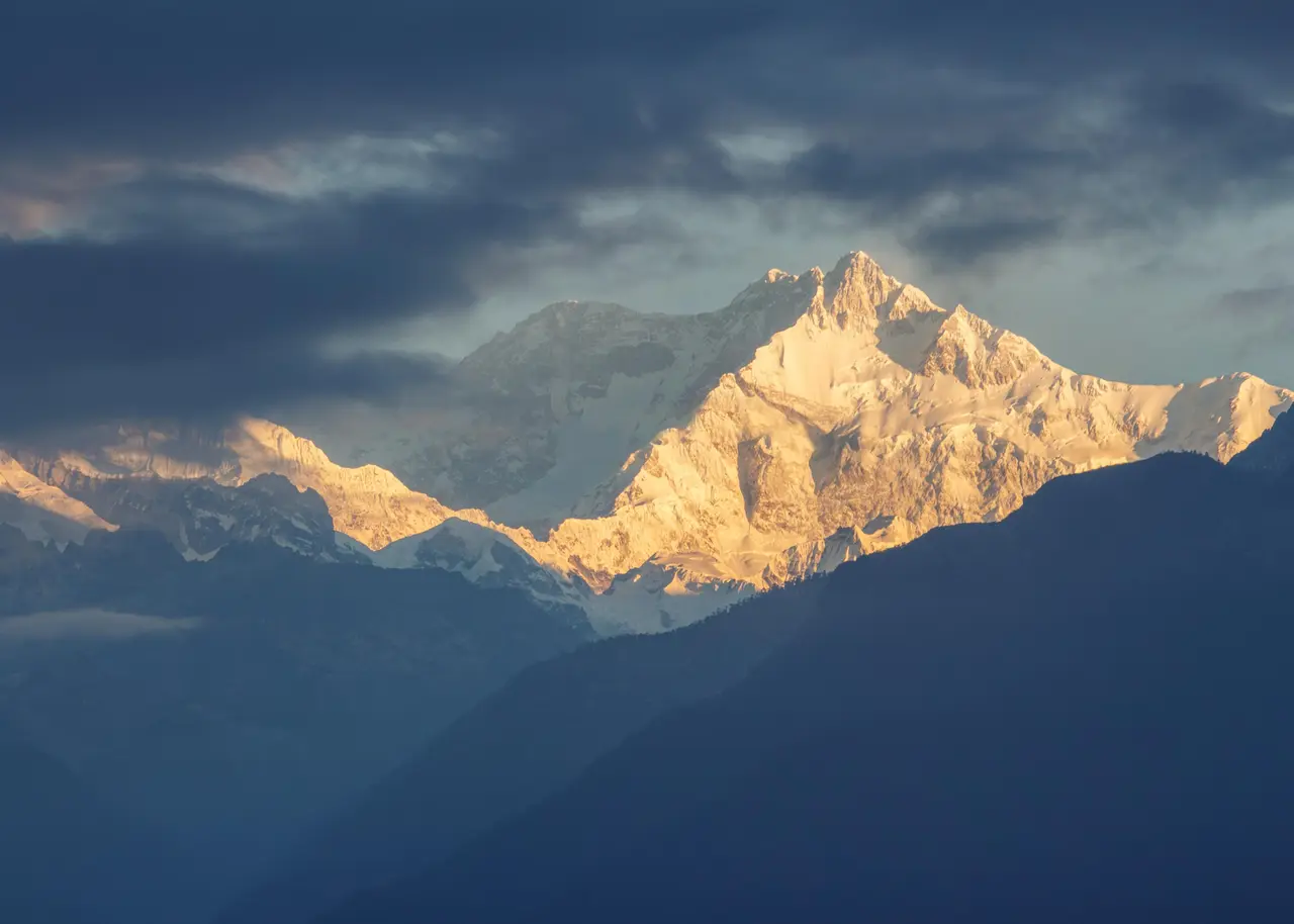 Spectacular sunrise lighting up Kanchenjunga peaks in Sikkim, India. Majestic winter landscape.